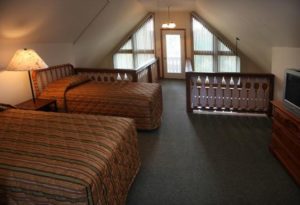 Loft bedroom with two twin beds in condo rental at Loreley Resort